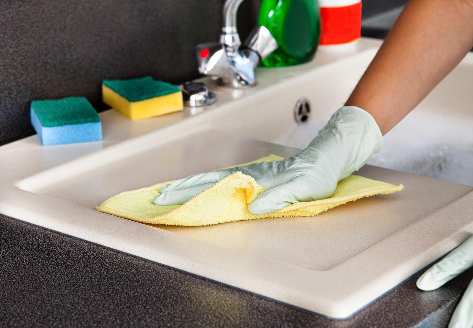 Cleaning a kitchen sink with gloves on