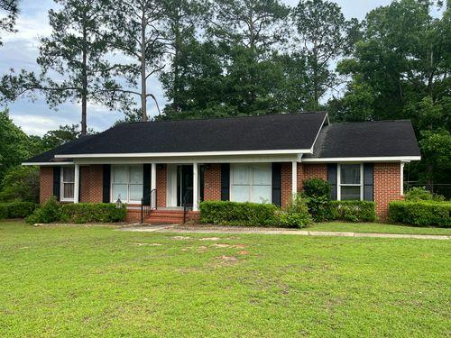 Front View from Overlook Drive, with inviting porch with black hand rails and shutters