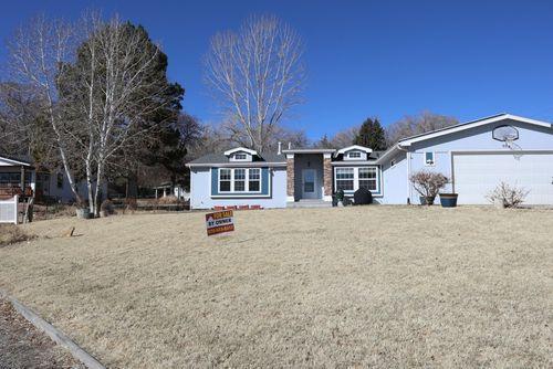 Front yard fully landscaped with mature trees
