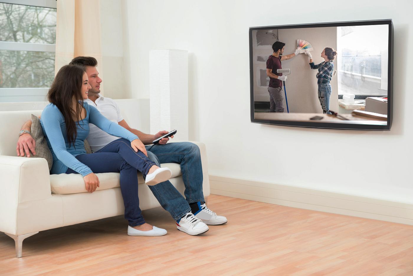Couple watching Reality TV House flipping show
