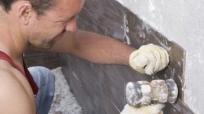 Man repairing foundation of home