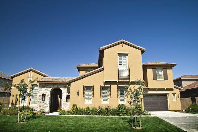 California home with green grass and concrete driveway.