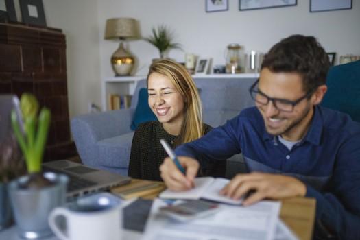 Couple at home sorting through bills and taxes
