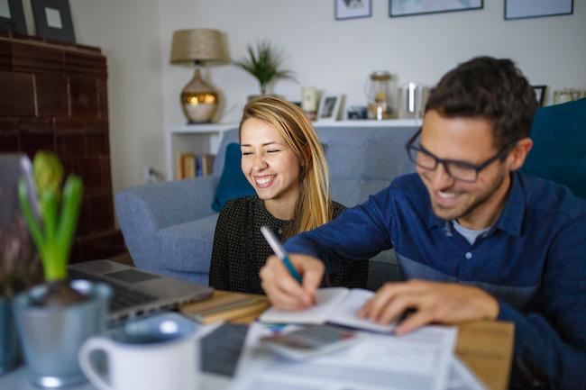Couple at home sorting through bills and taxes