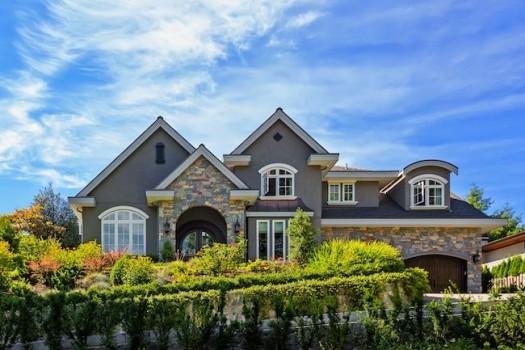Grey stone house on large lot.