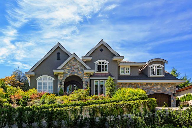 Grey stone house on large lot.