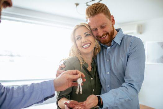 Happy couple moving in a new house.