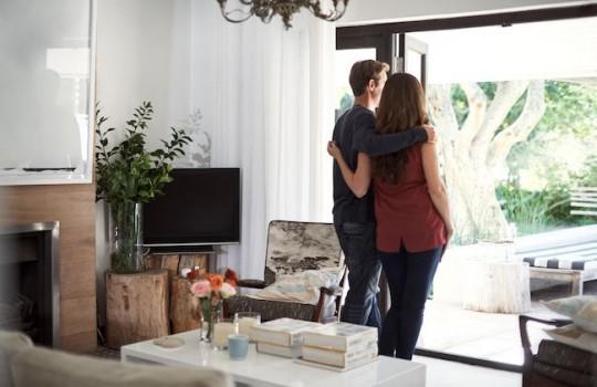 Husband and wife looking into their backyard.