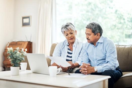couple on computer advertising their home online