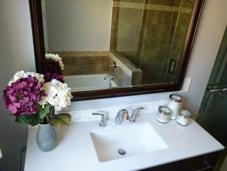 Bathroom sink with flowers and mirror