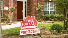 Foreclosure sign in yard of home for sale